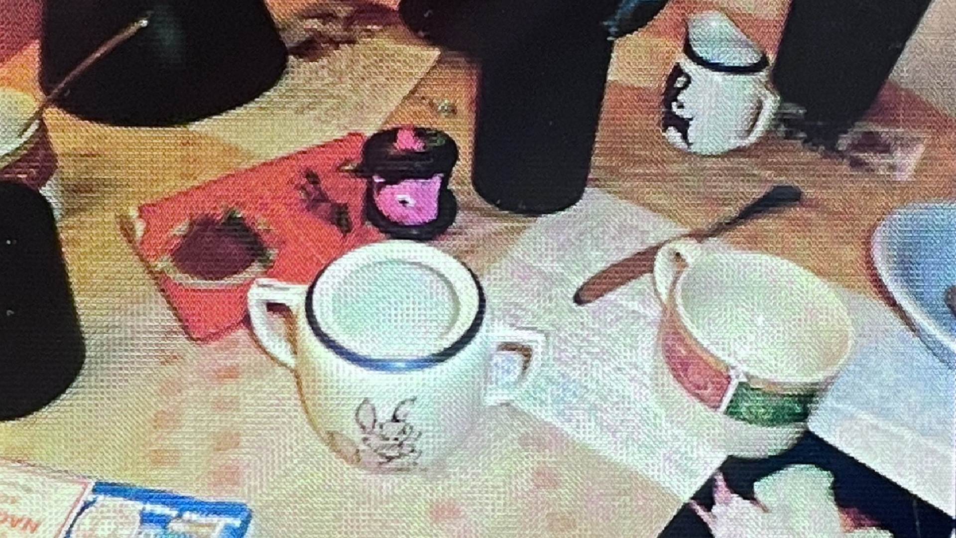 a close up photo with textile texture of a kettle, cup, and kitchenware on top of a table.